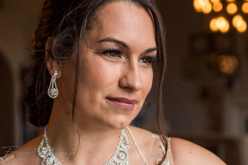 Blonde bride full length with white and green bouquet