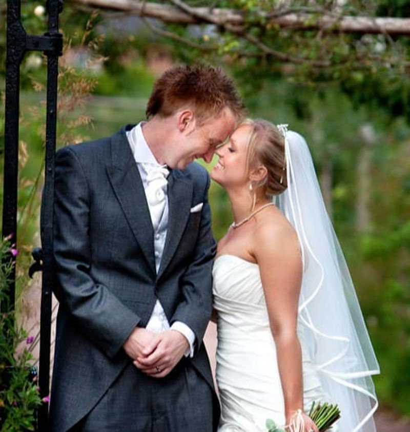 Romantic wedding portrait - bride and groom in garden