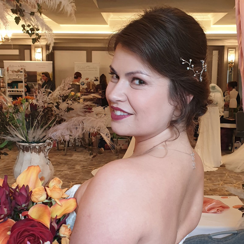 Bride in city with lace sleeve dress and natural makeup